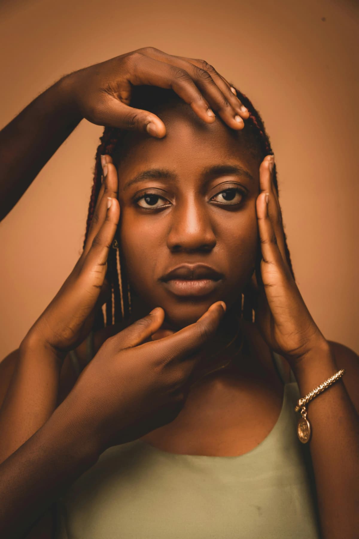 Portrait of a Mozambican woman with hands framing her face