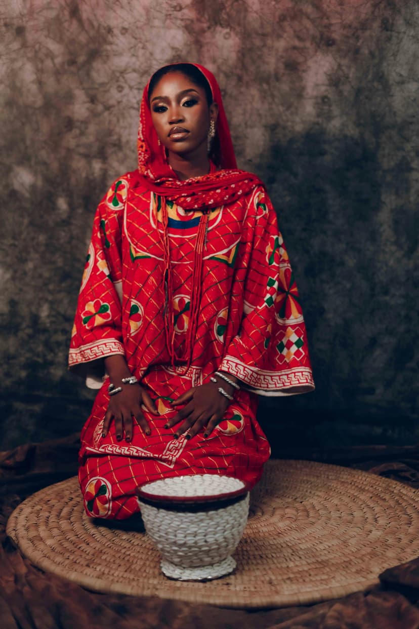 A woman in traditional red attire, representing study participants from Mozambique