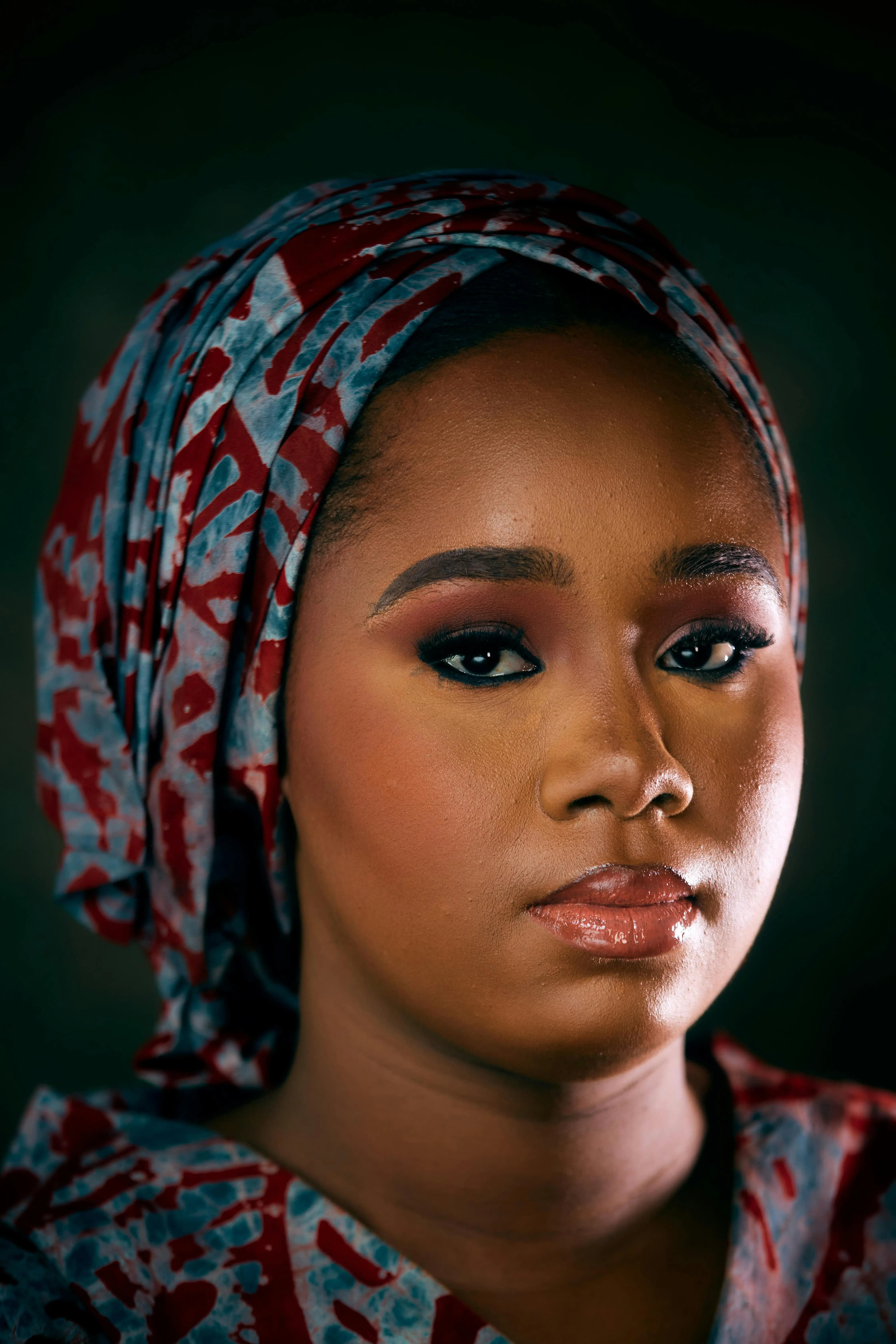 Close-up portrait with strong gaze against dark background